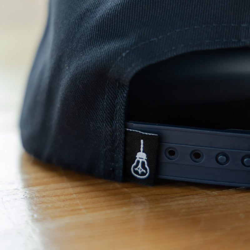 Side Project Logo with Barrel Navy Hat